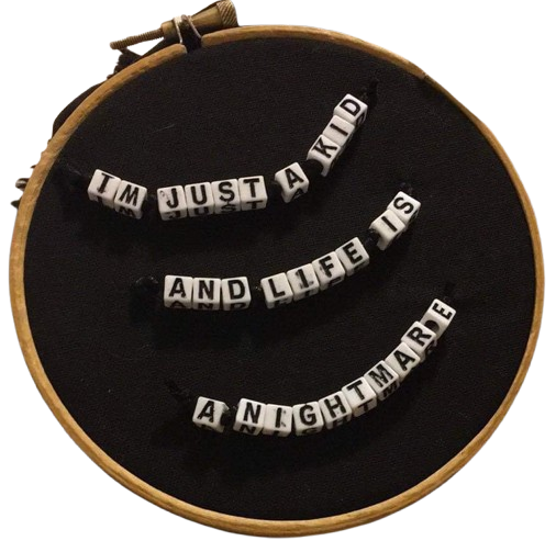 an embroidery hoop with beaded letters that say Im just a kid and life is a nightmare