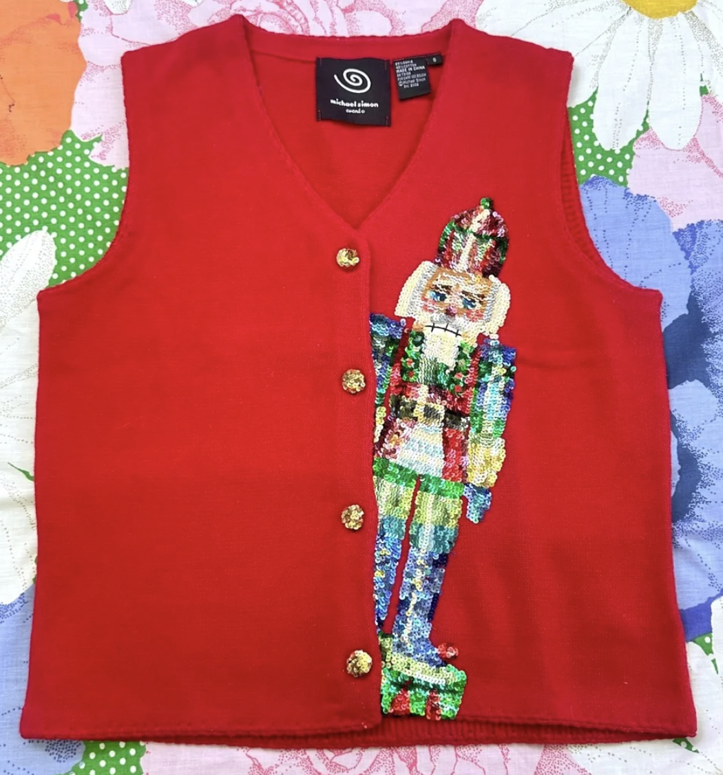 red button-up vest with a sequined nutcracker