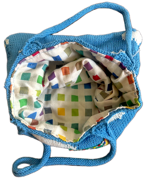 inside of the knitted tote with colorful fabric lining